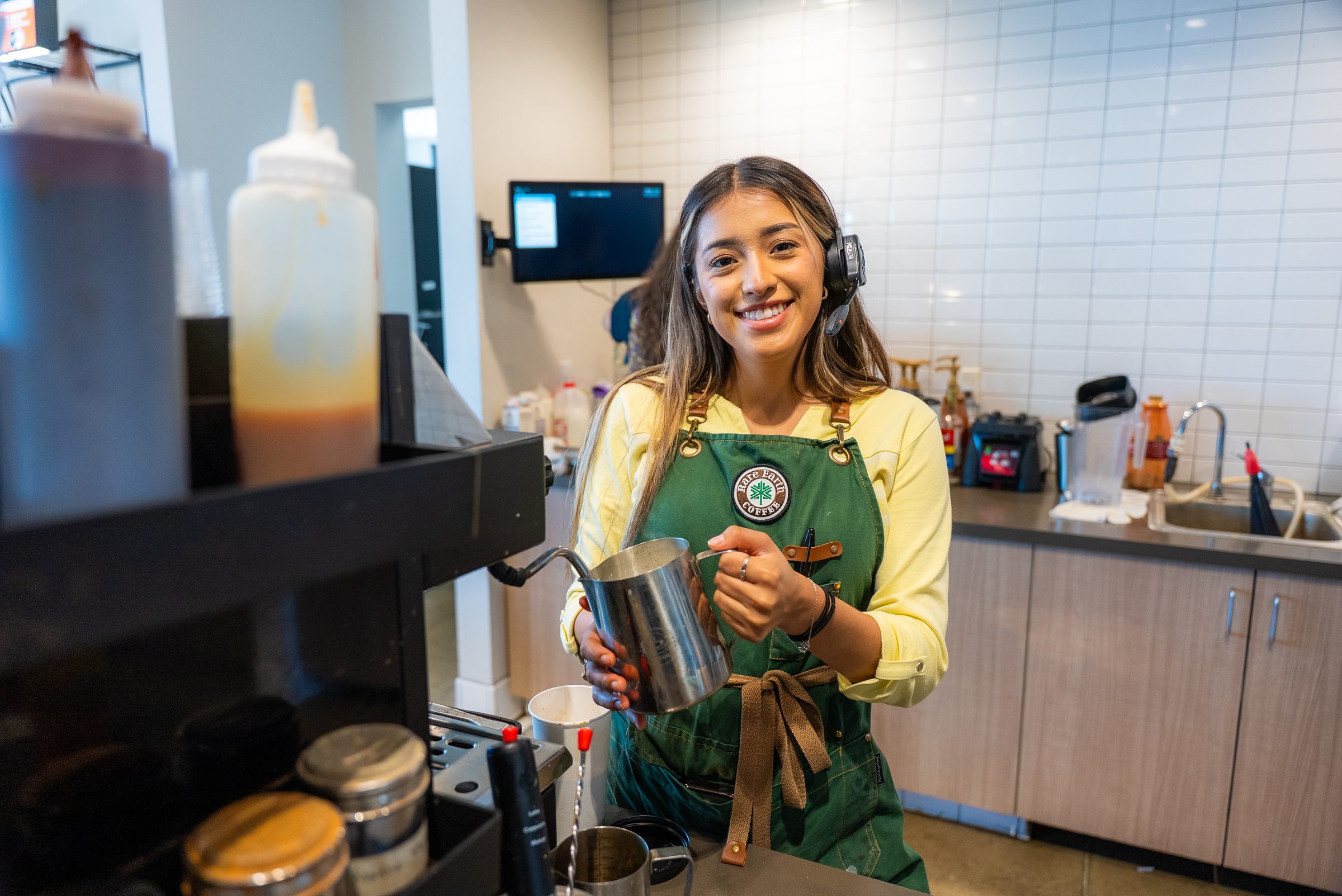 Barista making a drink at Rare Earth Coffee