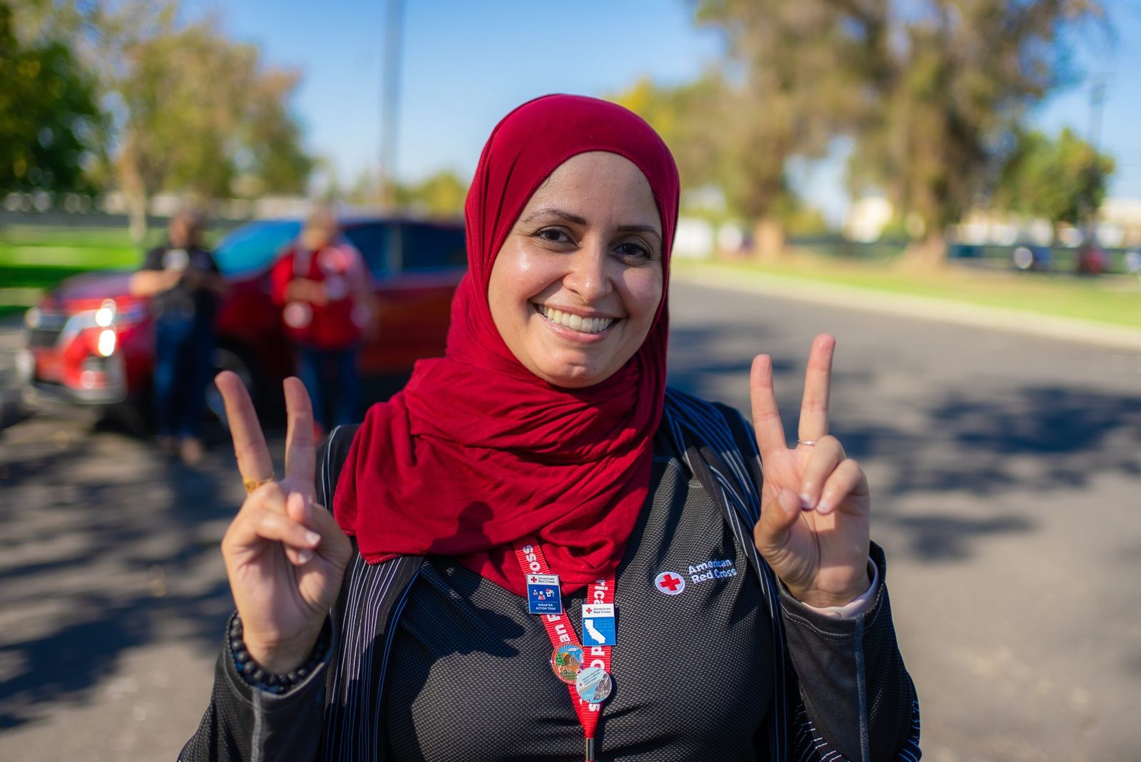 Volunteer with a peace sign — American Red Cross