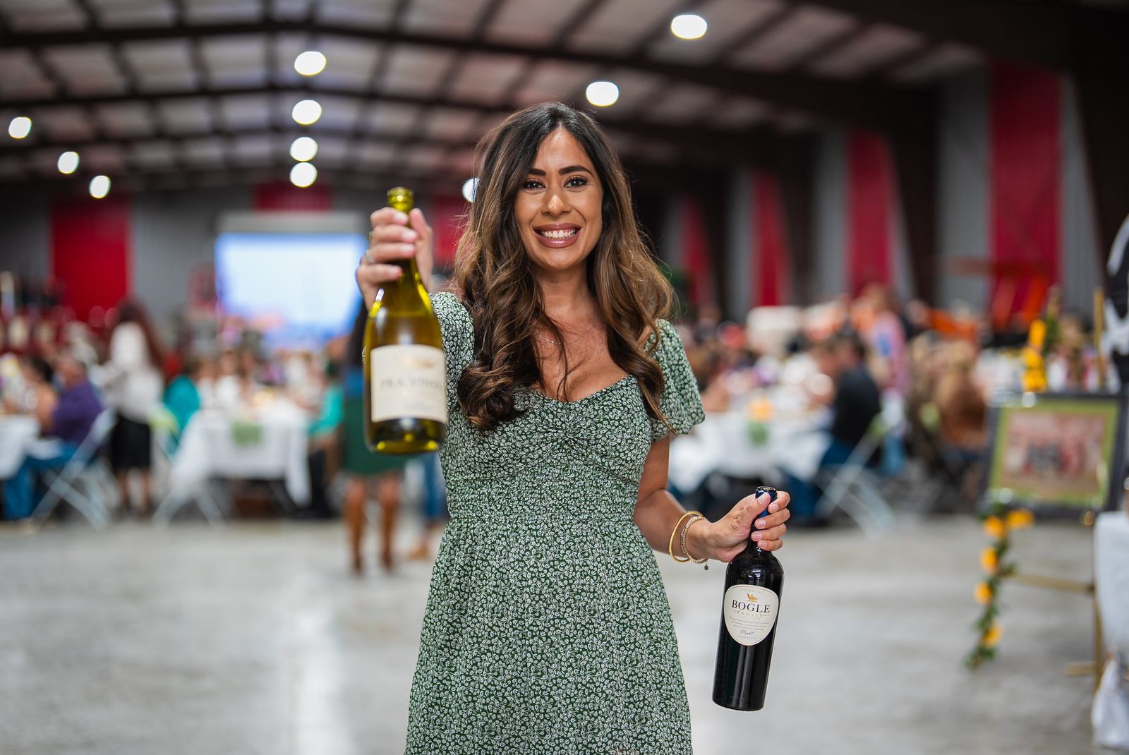Host with wine bottles — City of Los Banos