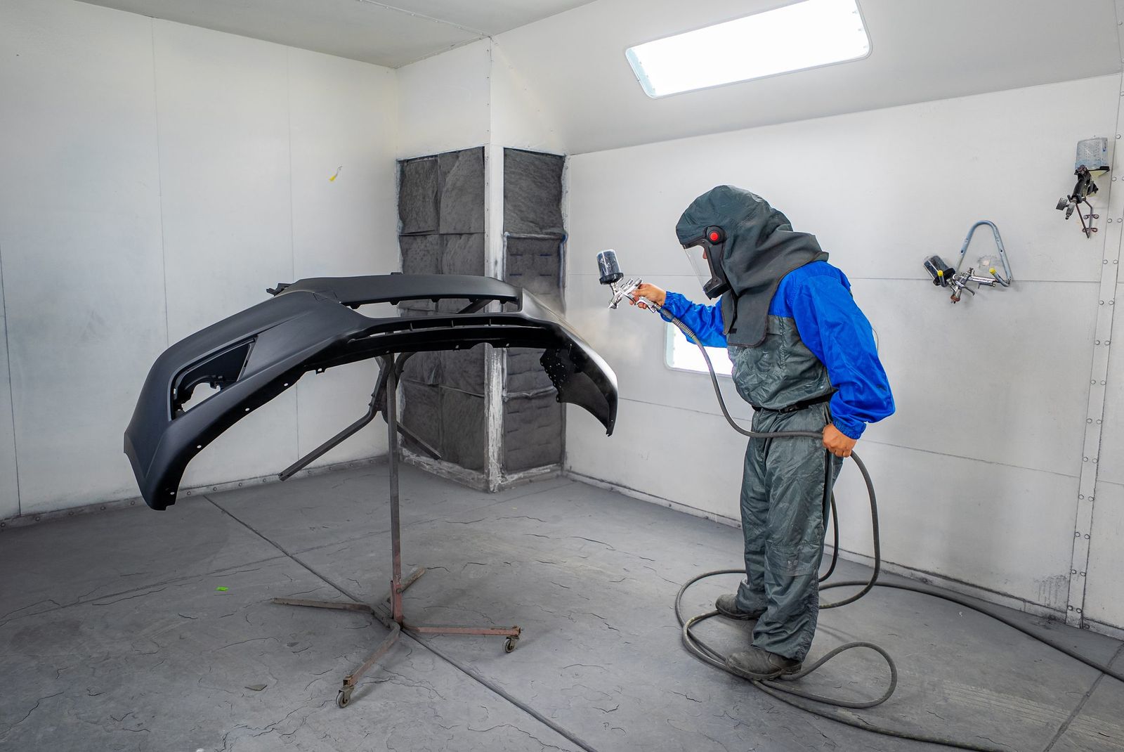 Spraying a bumper in the booth — City of Los Banos