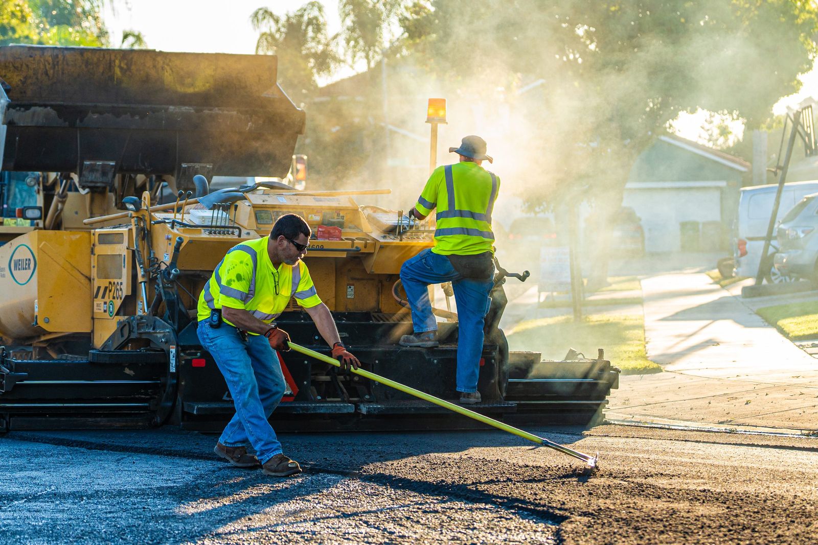 Raking asphalt by the paver — City of Los Banos