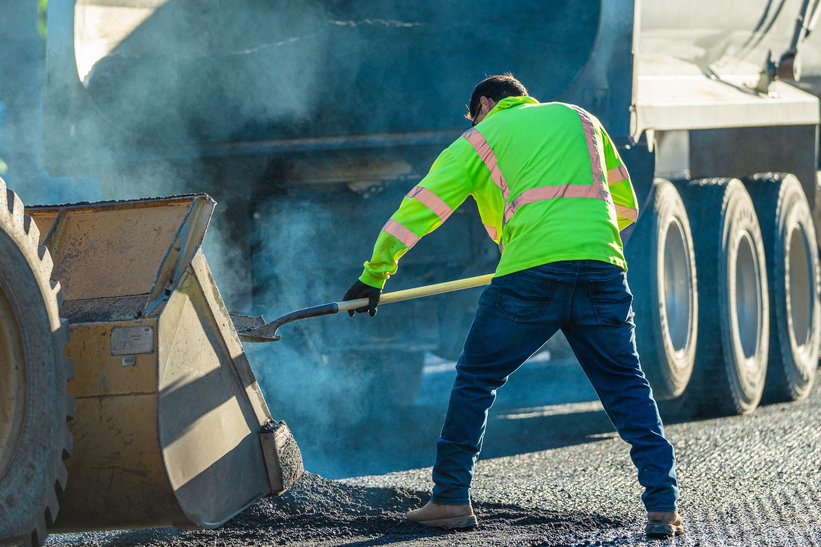 Shoveling asphalt in the steam — City of Los Banos