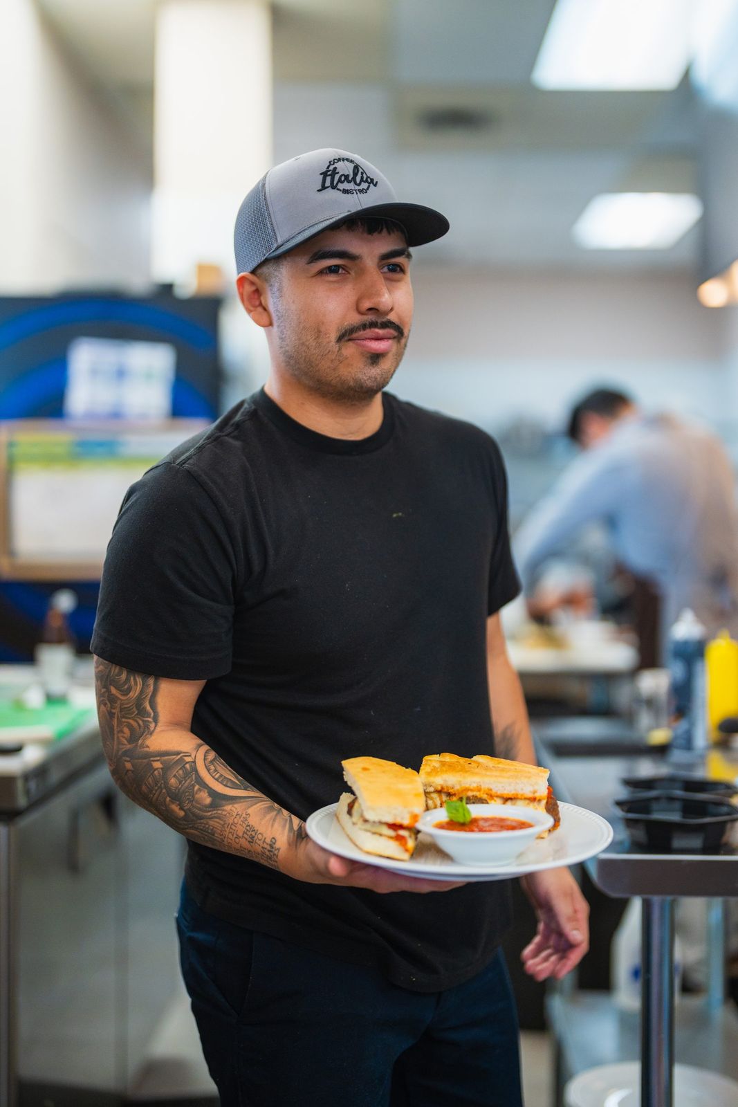 Chef holding a plated sandwich