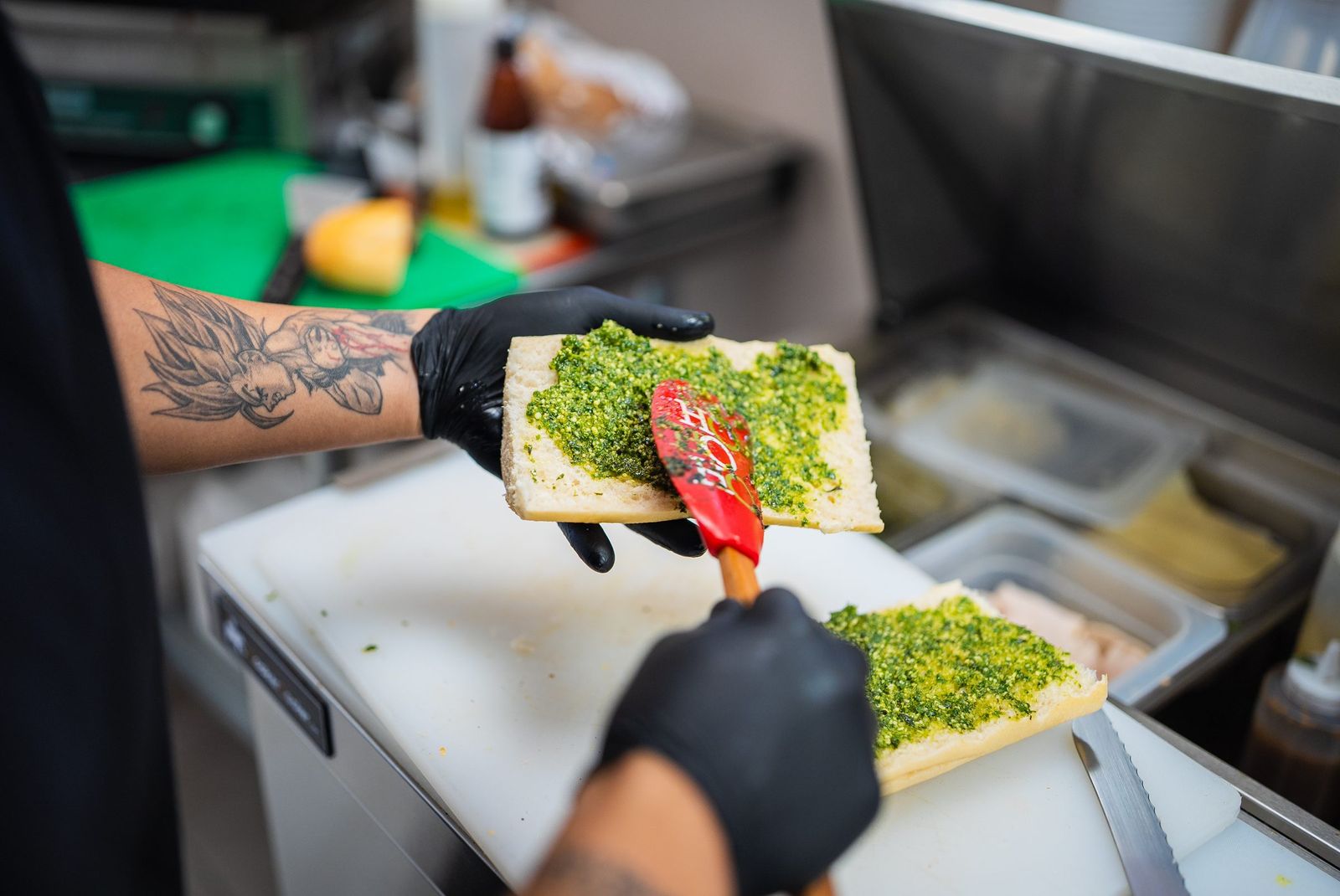 Spreading pesto on bread, close up