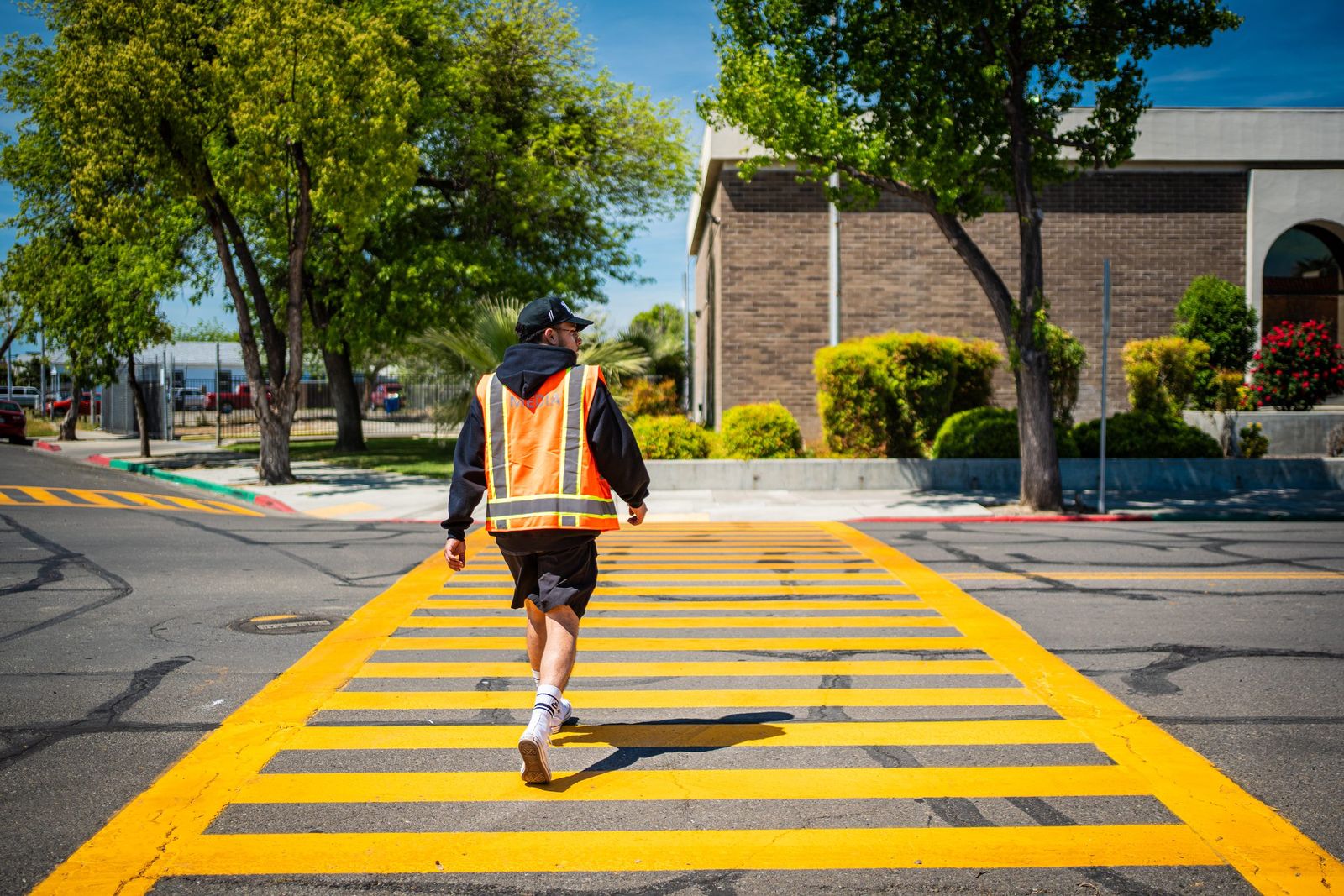 The Imagine Way More crew walking across a yellow crosswalk with their gear
