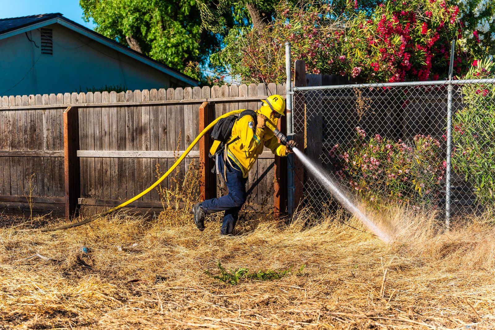 Grass fire along the fenceline — Los Banos Fire Department