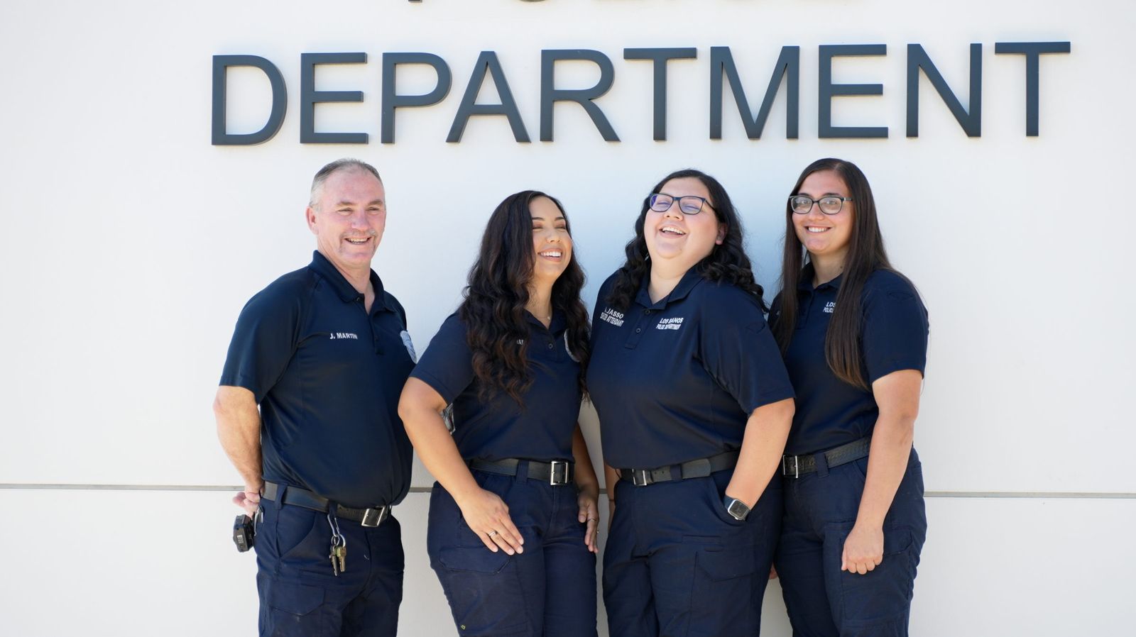 Laughing staff team portrait — Los Banos Police Department