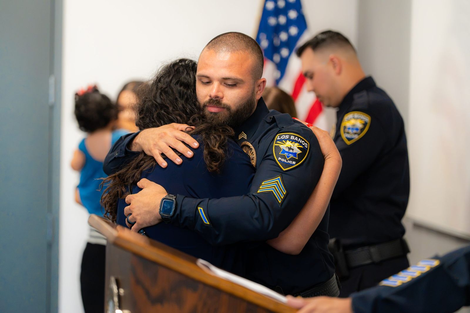 Family embrace at the ceremony — Los Banos Police Department