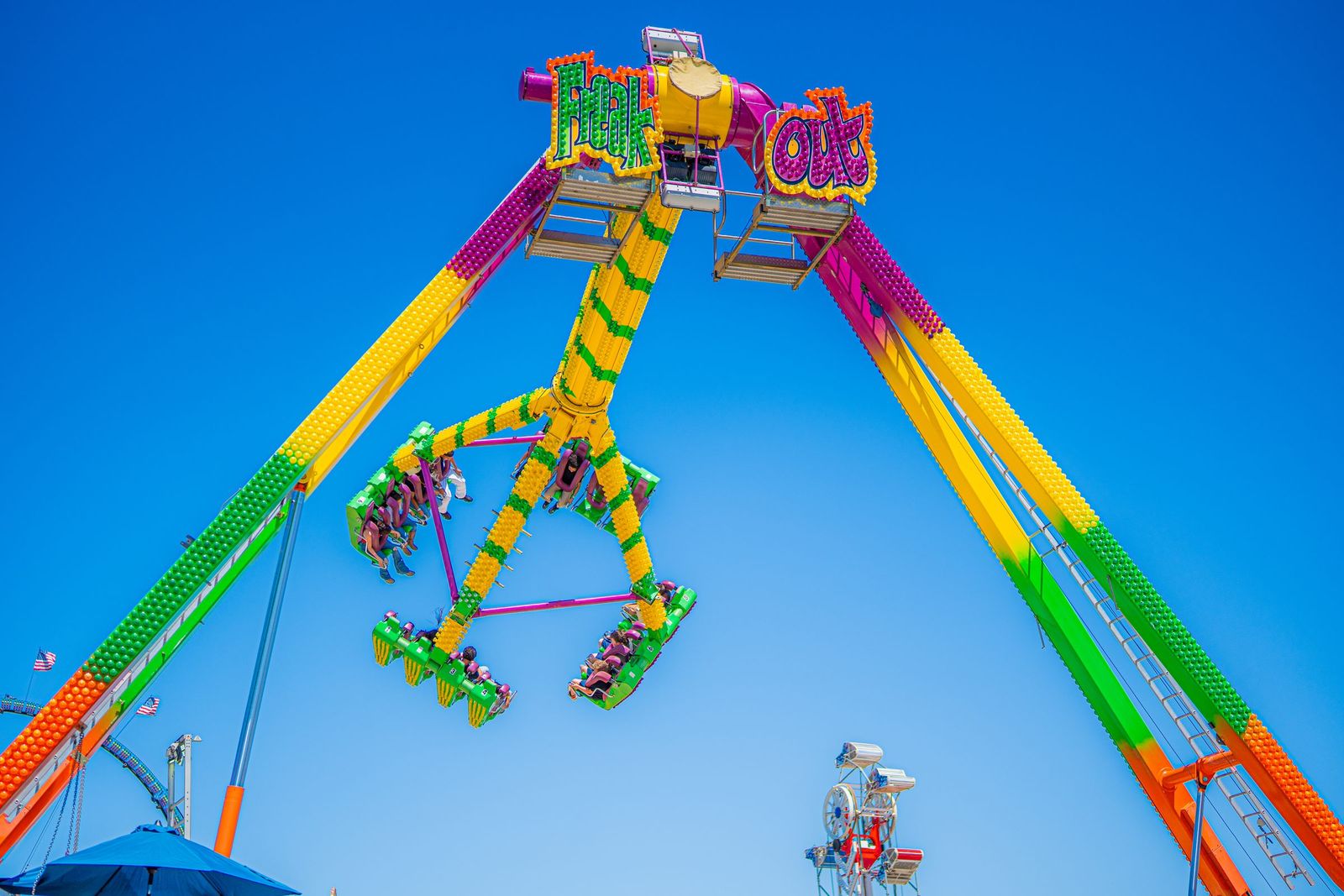 Thrill ride against blue sky — Merced County Fair