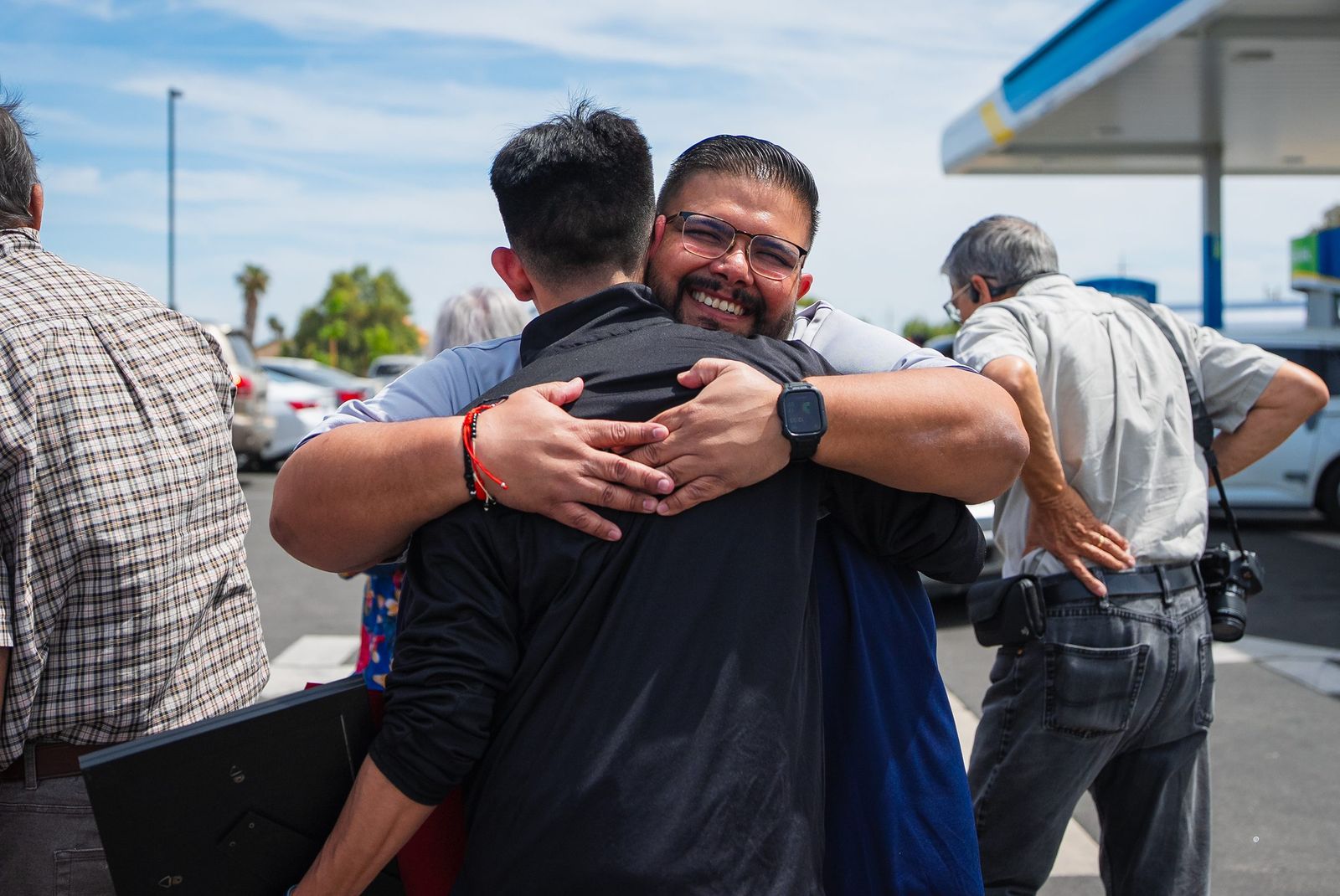 Celebration hug at the ribbon cutting — Rare Earth Coffee